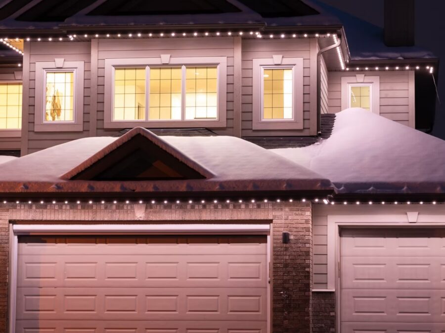 Home exterior with warm permanent lighting along the roofline